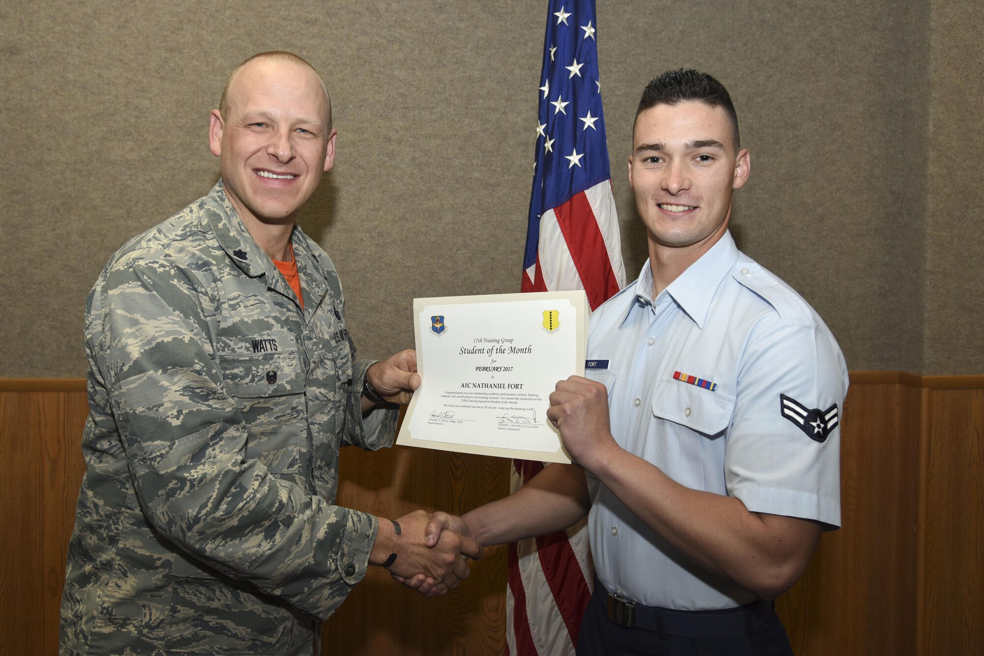 U.S. Air Force Lt. Col. Steven Watts, 17th Training Group deputy commander, presents the 312th Training Squadron Student of the Month award for Febuary 2017 to Airman 1st Class Nathaniel Fort, 312th TRS student, in the Brandenburg Hall on Goodfellow Air Force Base, Texas, March 3, 2017. (U.S. Air Force photo by Airman 1st Class Chase Sousa/Released)