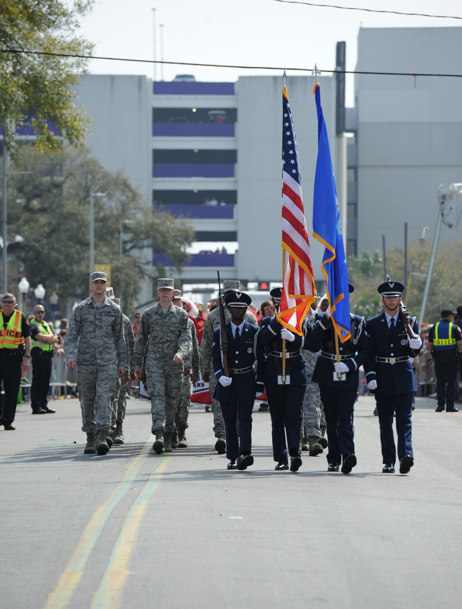 Members of the Keesler Air Force Base Honor Guard lead the Gulf Coast Carnival Association Mardi Gras parade Feb. 28, 2017, in Biloxi, Miss. Every Mardi Gras season, Keesler personnel participate in local parades to show their support of the communities surrounding the installation. (U.S. Air Force photo by Kemberly Groue)