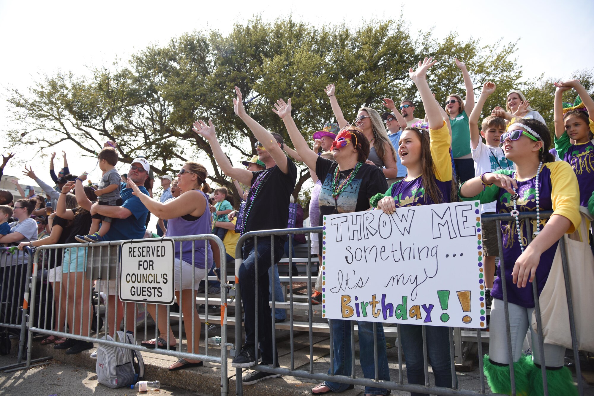 Parade attendees cheer during the Gulf Coast Carnival Association Mardi Gras parade Feb. 28, 2017, in Biloxi, Miss. The Keesler Honor Guard led the parade and members of base leadership also attended the event. (U.S. Air Force photo by Kemberly Groue)