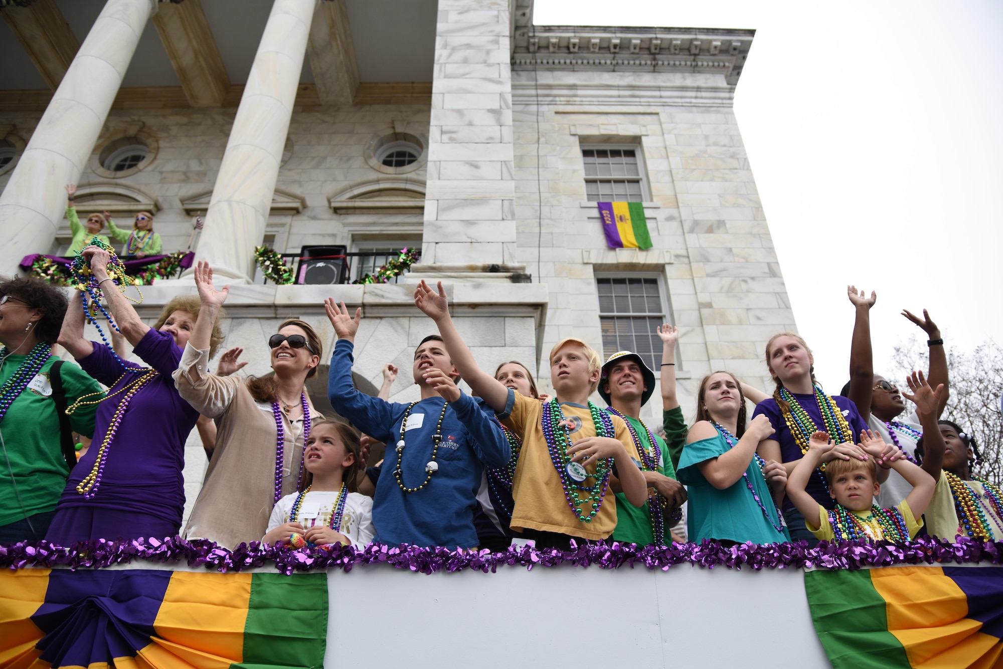 Keesler leadership and their families attend the Gulf Coast Carnival Association Mardi Gras parade Feb. 28, 2017, in Biloxi, Miss. Every Mardi Gras season, Keesler personnel participate in local parades to show their support of the communities surrounding the installation. (U.S. Air Force photo by Kemberly Groue)