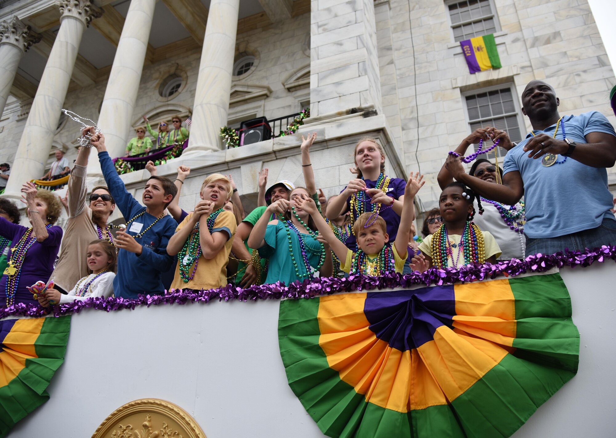 Keesler leadership and their families attend the Gulf Coast Carnival Association Mardi Gras parade Feb. 28, 2017, in Biloxi, Miss. Every Mardi Gras season, Keesler personnel participate in local parades to show their support of the communities surrounding the installation. (U.S. Air Force photo by Kemberly Groue)