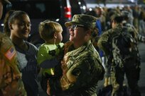 Staff Sgt. Ivelisse Vaughn says goodbye to her son Seth, daughter Seleen and husband Frank Vaughn during a farewell ceremony held on March 2, at the Fort Buchanan Community Club, less than one week after their Yellow Ribbon event.
