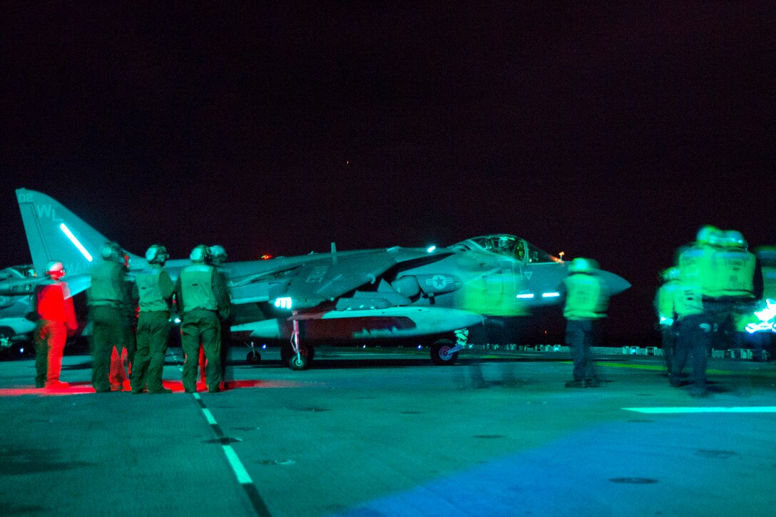 Sailors and Marines direct a Marine Corps AV-8B Harrier II on the flight deck of the amphibious assault ship USS Bonhomme Richard during night operations in the Philippine Sea, March 2, 2017. Navy photo by Petty Officer 2nd Class Diana Quinlan