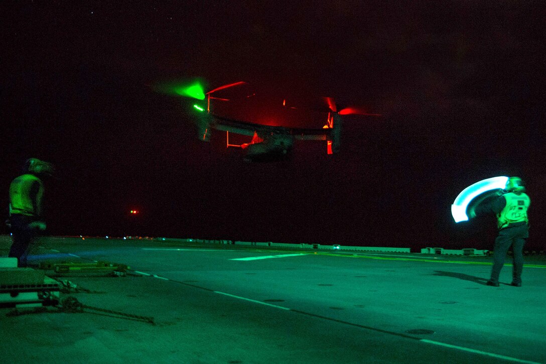 A Marine Corps MV-22B Osprey prepares to land on the flight deck of the amphibious assault ship USS Bonhomme Richard during night operations in the Philippine Sea, March 2, 2017. The Osprey is assigned to Marine Medium Tiltrotor Squadron 262. Navy photo by Petty Officer 2nd Class Diana Quinlan