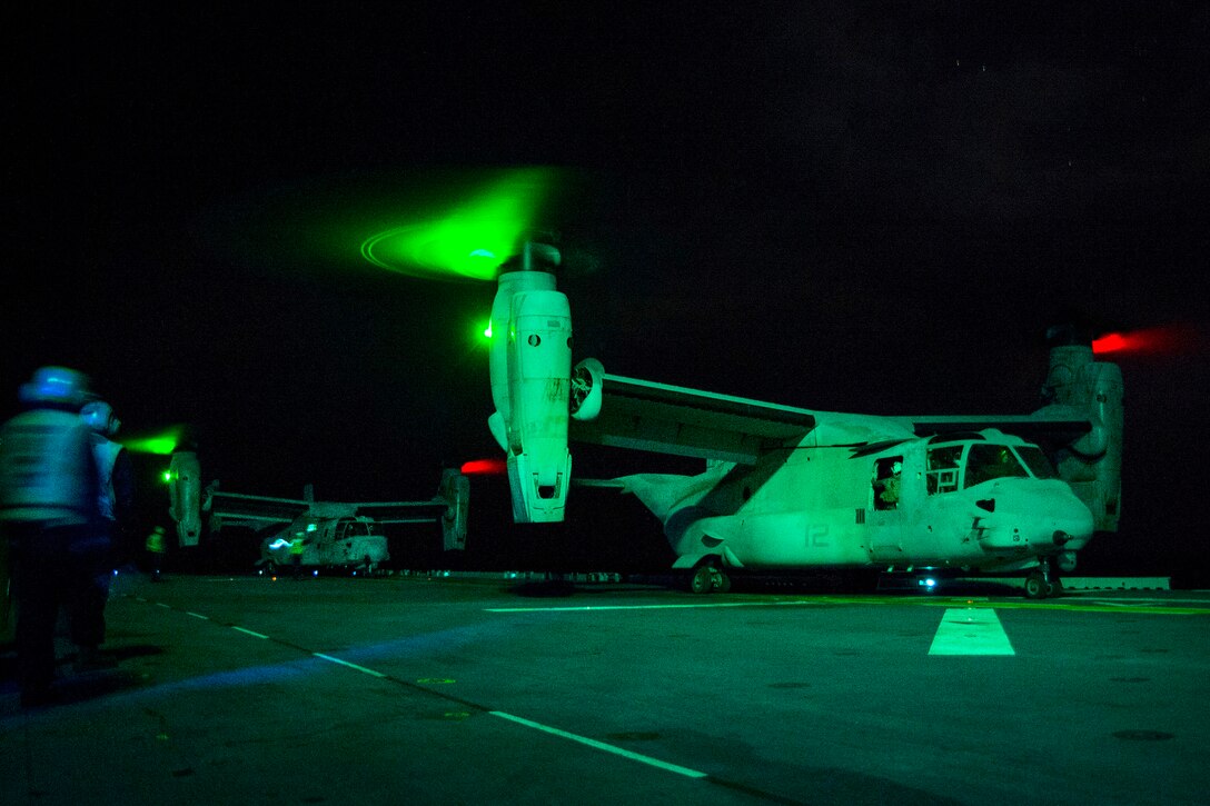 Marine Corps MV-22B Ospreys land on the flight deck of the amphibious assault ship USS Bonhomme Richard during night operations in the Philippine Sea, March 2, 2017. Navy photo by Petty Officer 2nd Class Diana Quinlan
