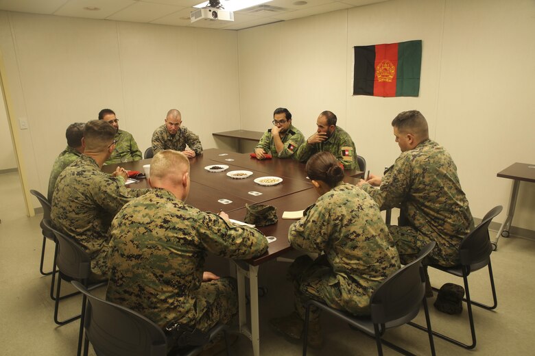 Marines with Task Force Southwest and Afghan role players speak during a full mission rehearsal at Camp Lejeune, N.C., Feb. 28, 2017. From Feb. 27 to March 3, approximately 300 Marines with the unit built their advisory and combat skills in preparation for an upcoming deployment to Helmand Province, Afghanistan.  Marines with Task Force Southwest will train, advise and assist the Afghan National Army 215th Corps and 505th Zone National Police, and are scheduled to deploy in the Spring. (U.S. Marine Corps photo by Sgt. Lucas Hopkins)