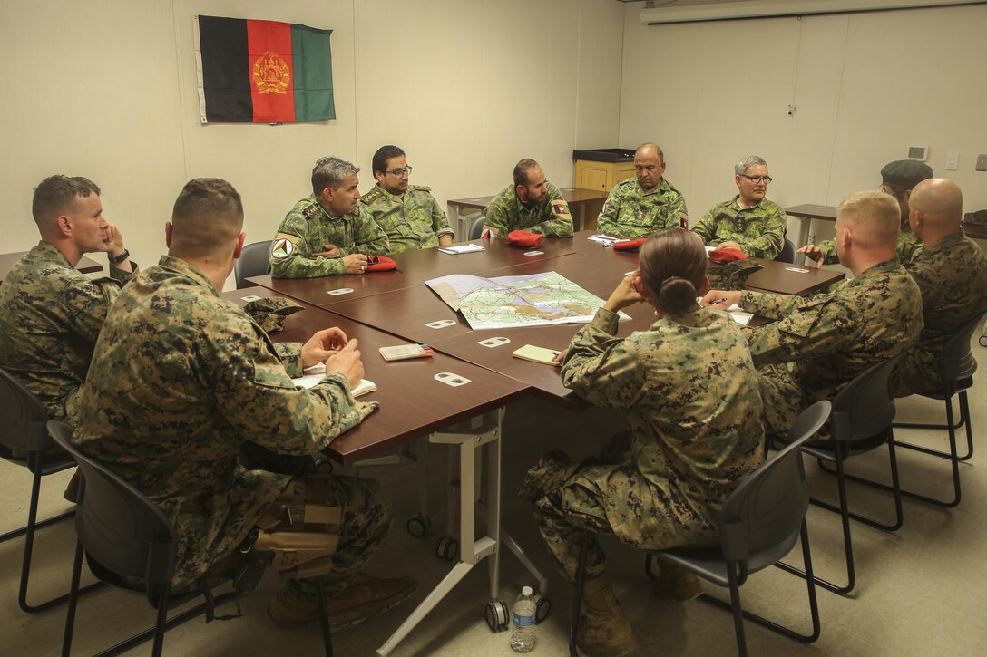 Afghan role players and Marines with Task Force Southwest hold an advisory meeting during a full mission rehearsal at Camp Lejeune, N.C., Feb. 28, 2017. Approximately 300 Marines with the unit enhanced their advisory, rapport-building and combat skills during the week-long exercise in preparation for an upcoming deployment to Helmand Province, Afghanistan. Marines with Task Force Southwest will train, advise and assist the Afghan National Army 215th Corps and 505th Zone National Police. (U.S. Marine Corps photo by Sgt. Lucas Hopkins)