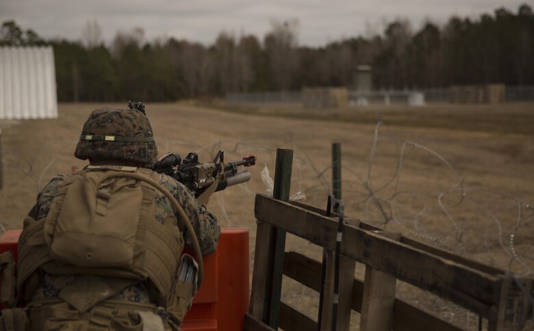 A Marine with Task Force Southwest scans the area for an enemy threat during the full mission rehearsal at forward operating base Bravo, Camp Lejeune, N.C., Feb. 28, 2017. The Marines worked with Afghan role players to gain better cultural understanding before deploying later this year to Helmand Province, Afghanistan. The Marines are scheduled to deploy as part of the task force to train, advise and assist the Afghan National Army 215th Corps and 505th Zone National Police. (U.S. Marine Corps photo by Sgt. Justin T. Updegraff)