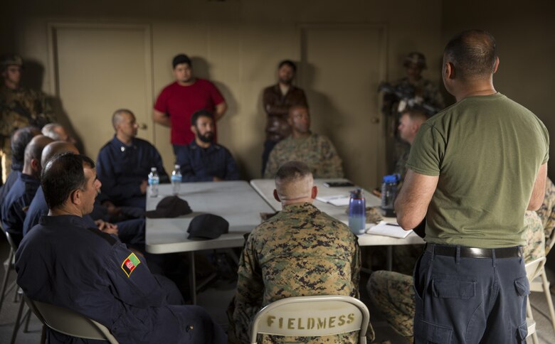 Marines with Task Force Southwest employ interpreters to help the language barrier during a staff meeting with Afghan role players during the full mission rehearsal at forward operating base Bravo, Camp Lejeune, N.C., Feb. 28, 2017. The Marines worked with Afghan role players to gain a better cultural understanding before deploying later this year to Helmand Province, Afghanistan.  The Marines are scheduled to deploy as part of the task force to train, advise and assist the Afghan National Army 215th Corps and 505th Zone National Police. (U.S. Marine Corps photo by Sgt. Justin T. Updegraff)
