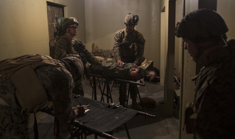 Marines with Task Force Southwest calm a notional casualty during a mass casualty drill during the full mission rehearsal at forward operating base Bravo, Camp Lejeune, N.C., Feb. 28, 2017. The Marines are scheduled to deploy later this year as part of the task force to train, advise and assist the Afghan National Army 215th Corps and 505th Zone National Police in Helmand Province, Afghanistan. (U.S. Marine Corps photo by Sgt. Justin T. Updegraff)