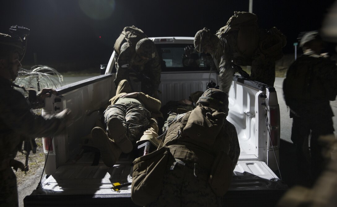 Marines with Task Force Southwest load two notional casualties during a mass casualty drill during the final mission rehearsal at forward operating base Bravo, Camp Lejeune, N.C., Feb. 28, 2017. The Marines are scheduled to deploy later this year as part of the task force to train, advise and assist the Afghan National Army 215th Corps and 505th Zone National Police in Helmand Province, Afghanistan. (U.S. Marine Corps photo by Sgt. Justin T. Updegraff)