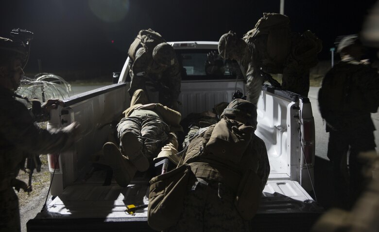 Marines with Task Force Southwest load two notional casualties during a mass casualty drill during the final mission rehearsal at forward operating base Bravo, Camp Lejeune, N.C., Feb. 28, 2017. The Marines are scheduled to deploy later this year as part of the task force to train, advise and assist the Afghan National Army 215th Corps and 505th Zone National Police in Helmand Province, Afghanistan. (U.S. Marine Corps photo by Sgt. Justin T. Updegraff)