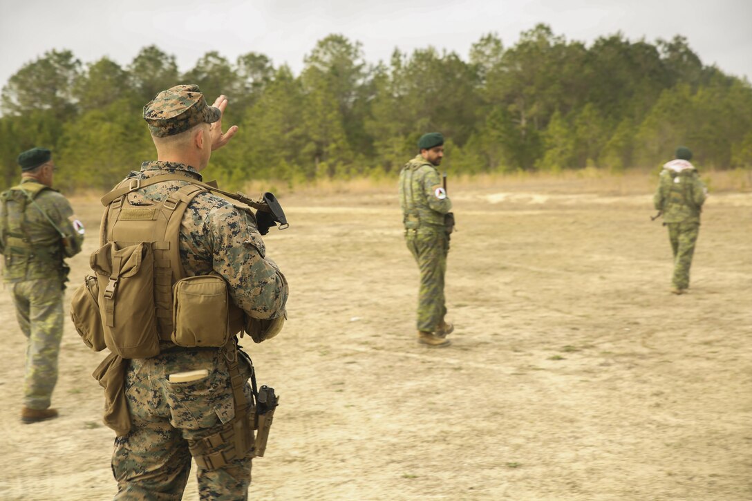 A Marine with Task Force Southwest instructs Afghan role players on proper patrolling techniques during a full mission rehearsal at Camp Lejeune, N.C., March 1, 2017. Throughout the week-long exercise, the Marines enhanced their advisory and combat skills in preparation for an upcoming deployment to Helmand Province, Afghanistan. Task Force Southwest is comprised of approximately 300 Marines who will train, advise and assist the Afghan National Army 215th Corps and 505th Zone National Police. (U.S. Marine Corps photo by Sgt. Lucas Hopkins)