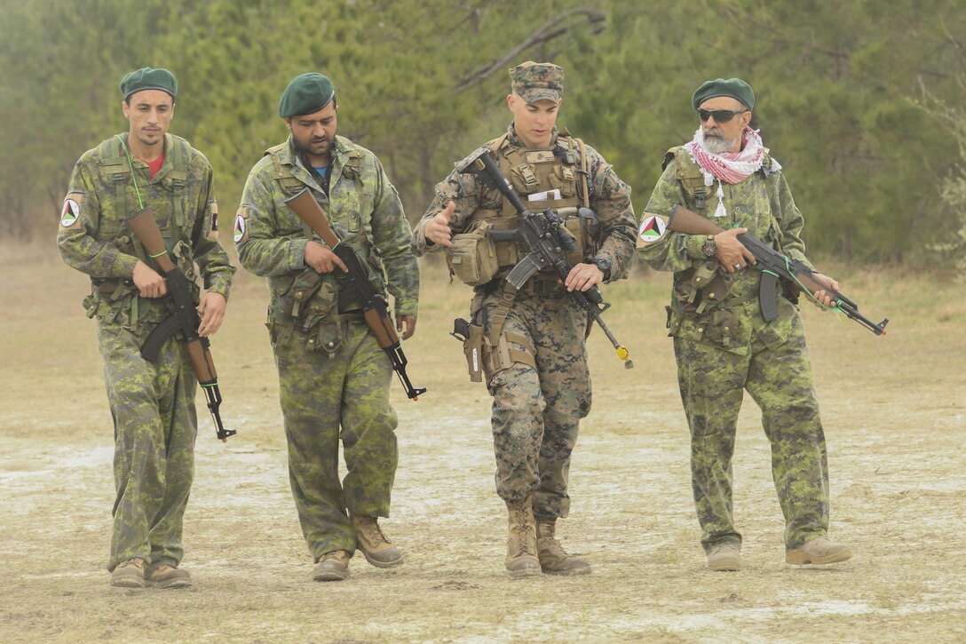 A Marine with Task Force Southwest speaks with Afghan role players during a full mission rehearsal at Camp Lejeune, N.C., March 1, 2017. Approximately 300 Marines with the unit built their advisory skills and combat capabilities during the week-long exercise. Marines with Task Force Southwest are scheduled to deploy to Helmand Province, Afghanistan later this year, and will train, advise and assist the Afghan National Army 215th Corps and 505th Zone National Police. (U.S. Marine Corps photo by Sgt. Lucas Hopkins)