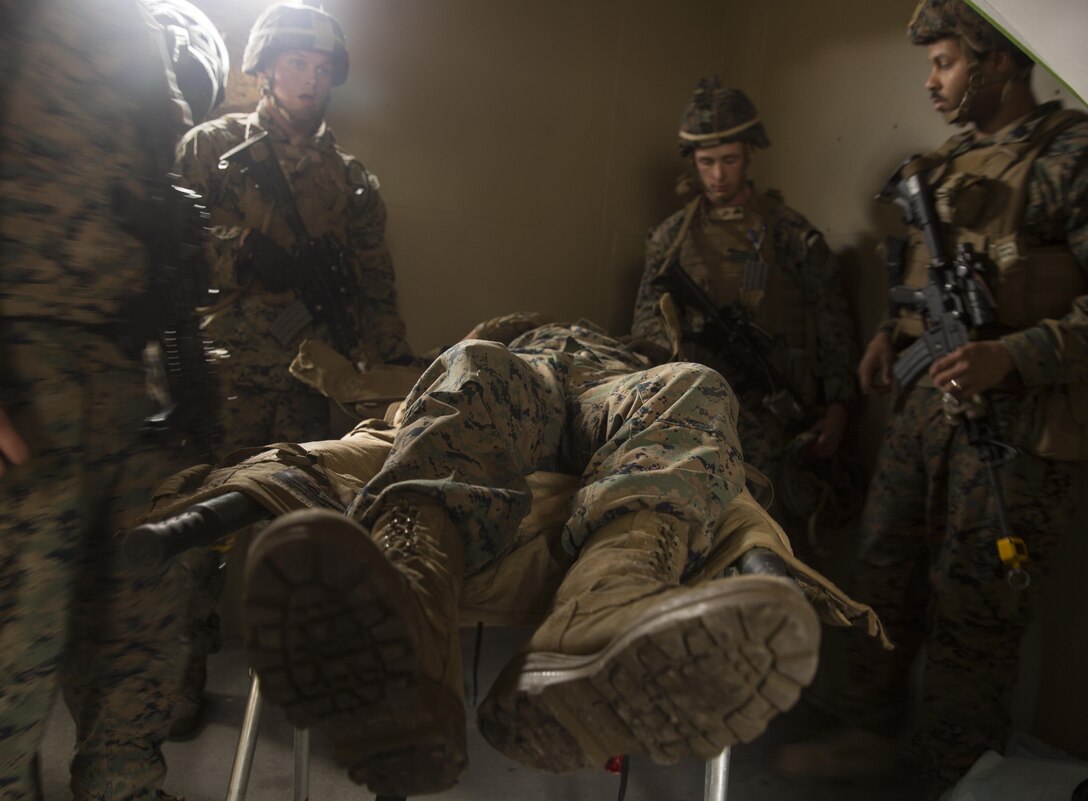 Marines with Task Force Southwest bring in a notional injured Marine to the aid station during a mass casualty drill rehearsal at forward operating base Bravo, Camp Lejeune, N.C., Feb. 28, 2017. The Marines are scheduled to deploy later this year as part of the task force to train, advise and assist the Afghan National Army 215th Corps and 505th Zone National Police in Helmand Province, Afghanistan. (U.S. Marine Corps photo by Sgt. Justin T. Updegraff)