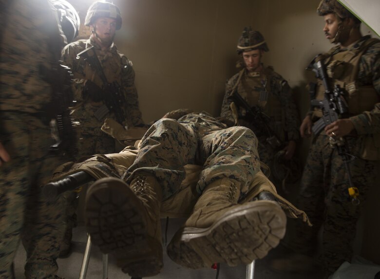Marines with Task Force Southwest bring in a notional injured Marine to the aid station during a mass casualty drill rehearsal at forward operating base Bravo, Camp Lejeune, N.C., Feb. 28, 2017. The Marines are scheduled to deploy later this year as part of the task force to train, advise and assist the Afghan National Army 215th Corps and 505th Zone National Police in Helmand Province, Afghanistan. (U.S. Marine Corps photo by Sgt. Justin T. Updegraff)