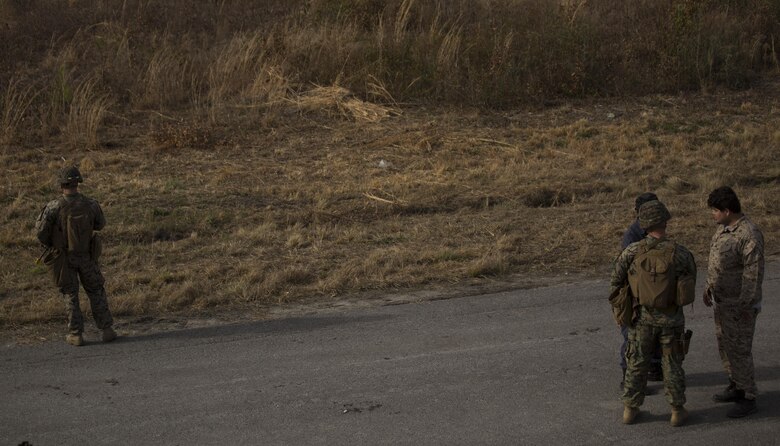 A Marine with Task Force Southwest provides security for another Marine and an interpreter during the full mission rehearsal at forward operating base Bravo, Camp Lejeune, N.C., Feb. 28, 2017. The Marines are scheduled to deploy as part of the task force to train, advise and assist the Afghan National Army 215th Corps and 505th Zone National Police. (U.S. Marine Corps photo by Sgt. Justin T. Updegraff)