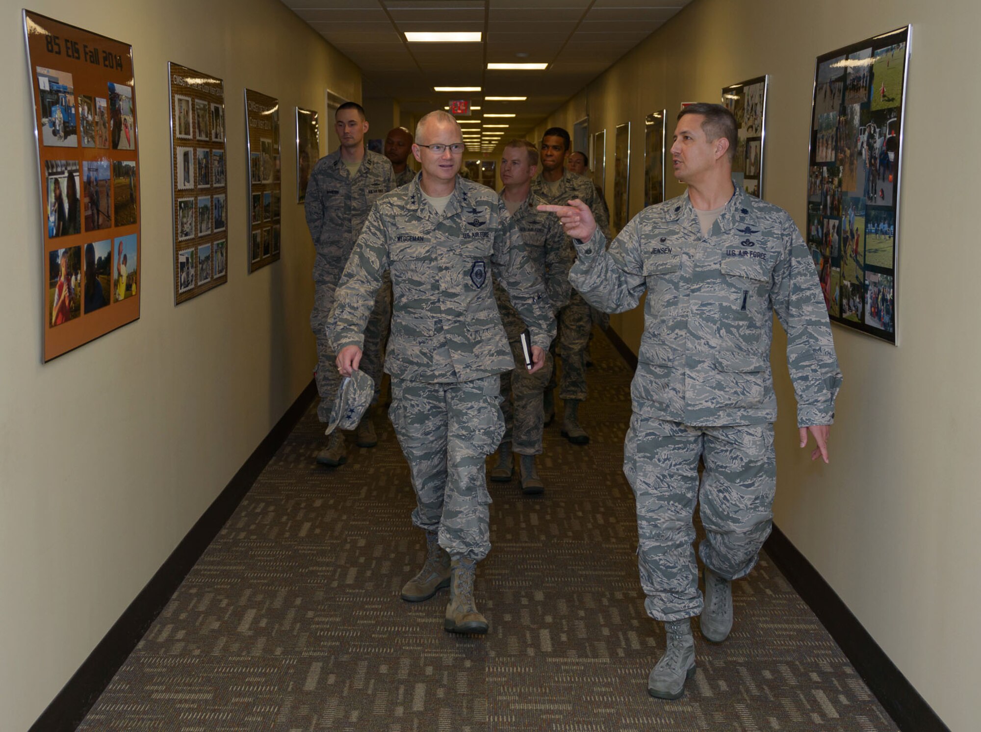 Lt. Col. Scott Jensen, 85th Engineering Installation Squadron commander, points out squadron mission photo displays to Maj. Gen. Christopher Weggeman, 24th Air Force commander, Joint Base San Antonio-Lackland, Texas, at Maltby Hall during a site visit March 1, 2017, on Keesler Air Force Base, Miss. Weggeman visited with Airmen linked to the cyber curriculum and received an 85th mission brief. (U.S. Air Force photo by André Askew)