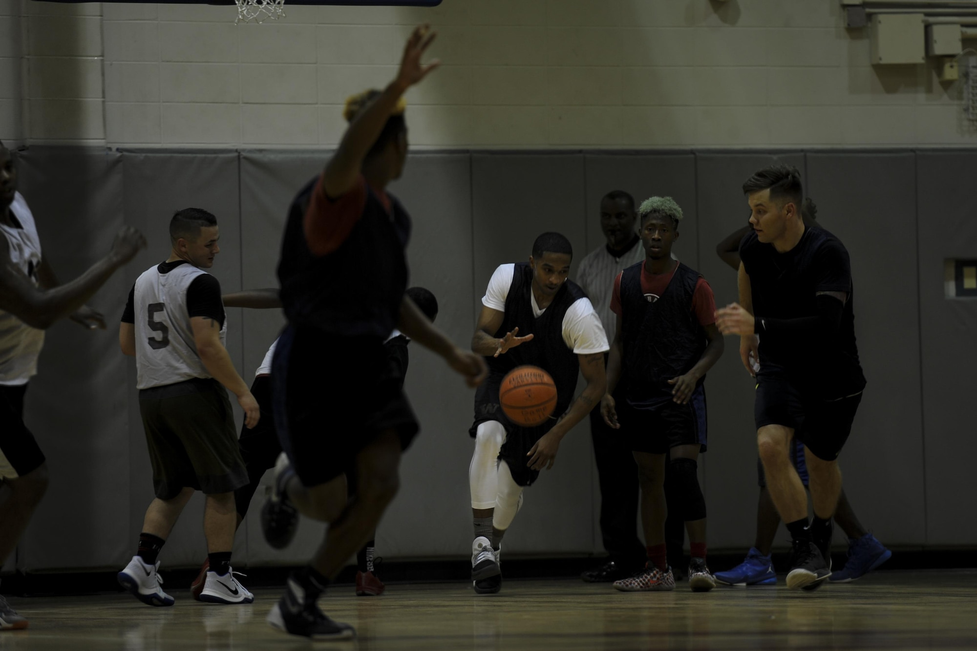 Nate Walker, a power forward for the 1st Special Operations Contracting Squadron intramural basketball team, dribbles the ball during a basketball game at Hurlburt Field, Fla., March 3, 2017. The 1st SOCONS defeated the 1st Special Operations Maintenance Squadron 78-62. (U.S. Air Force photo by Airman 1st Class Dennis Spain)