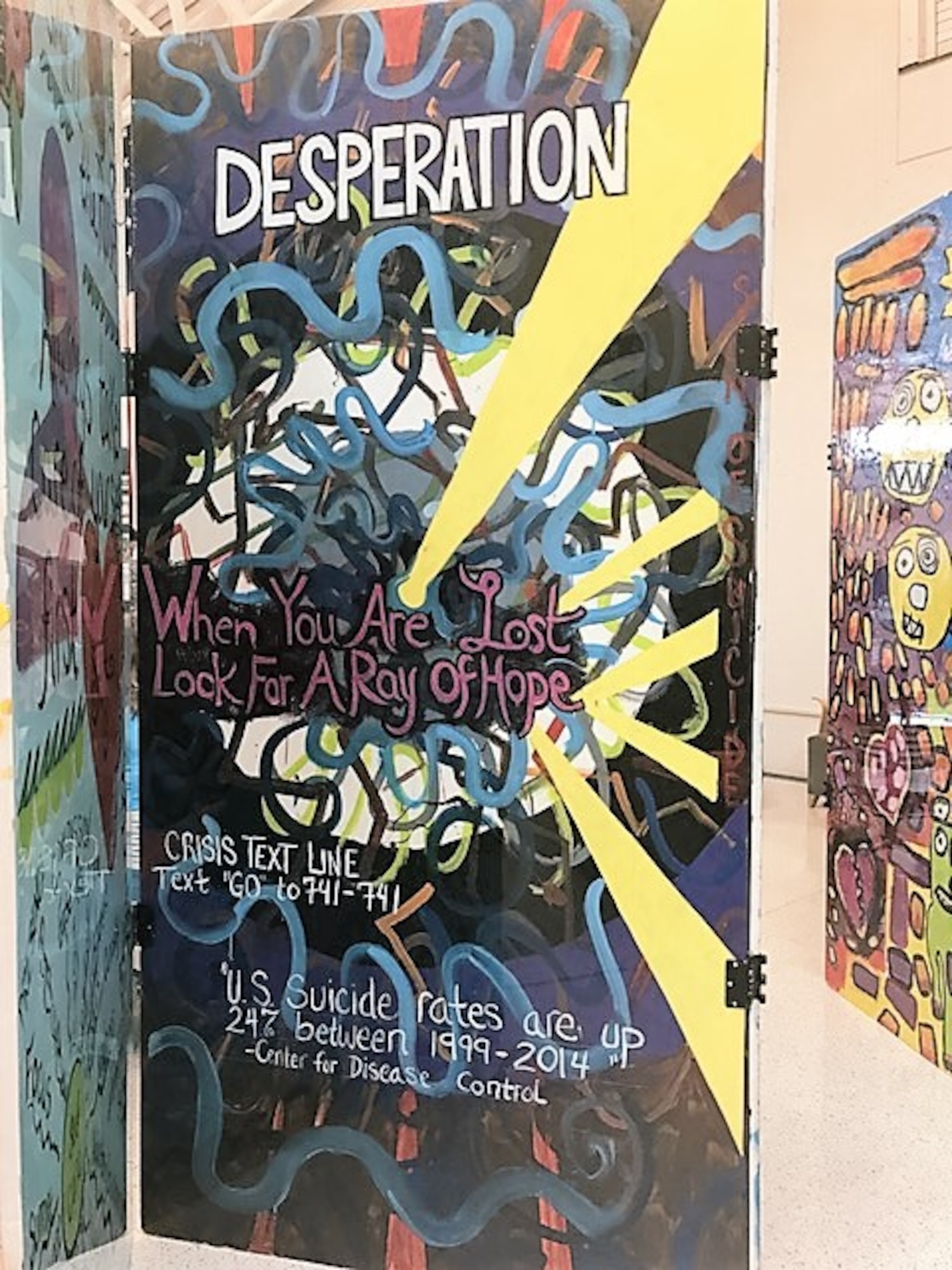 The Signs of Suicide Project displayed at the 88th Medical Group are made up of 30 visual images painted onto panels covered with honest and direct messages relating to issues of suicide. (U.S. Air Force photo/Stacey Geiger)  