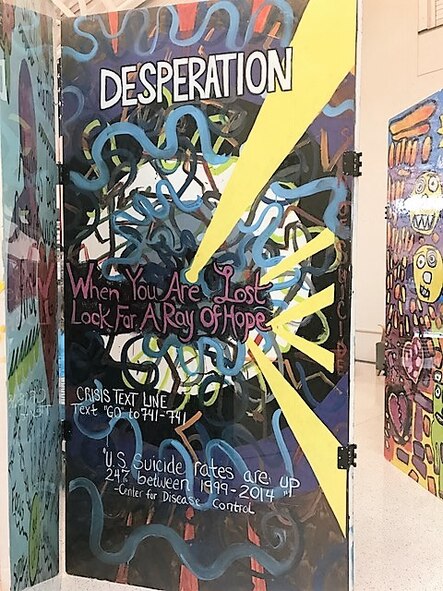 The Signs of Suicide Project displayed at the 88th Medical Group are made up of 30 visual images painted onto panels covered with honest and direct messages relating to issues of suicide. (U.S. Air Force photo/Stacey Geiger)  