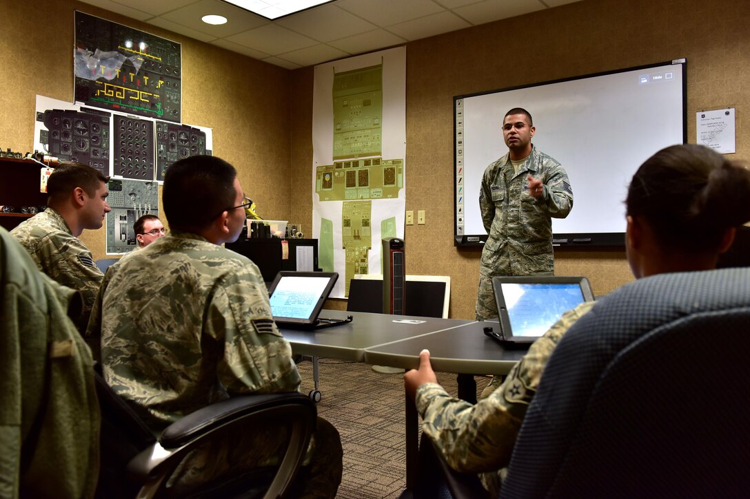 U.S. Air Force Tech. Sgt. Jose Piedra, standing, 373rd Training Squadron Detachment 4 production supervisor and instructor, goes over a final review before issuing a test to his students Feb. 23, 2017 at the Center of Excellence on Little Rock Air Force Base, Ark.  Piedra instructs more than 80 students annually in C-130J maintenance and certification.  (U.S. Air Force photo by Staff Sgt. Jeremy McGuffin)