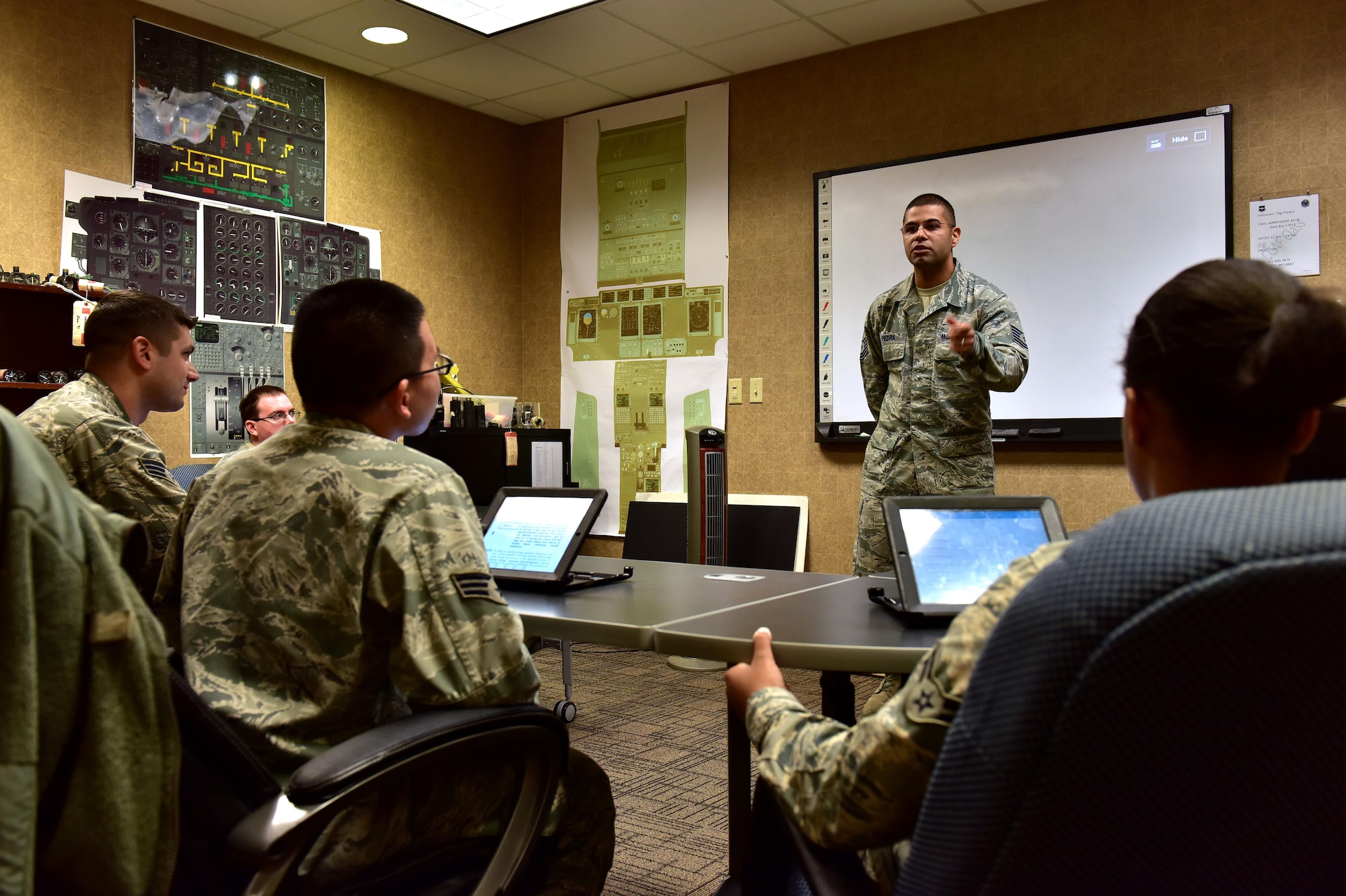 U.S. Air Force Tech. Sgt. Jose Piedra, standing, 373rd Training Squadron Detachment 4 production supervisor and instructor, goes over a final review before issuing a test to his students Feb. 23, 2017 at the Center of Excellence on Little Rock Air Force Base, Ark.  Piedra instructs more than 80 students annually in C-130J maintenance and certification.  (U.S. Air Force photo by Staff Sgt. Jeremy McGuffin)