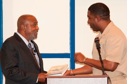 DAHLGREN, Va. - Capt. Godfrey "Gus" Weekes, Naval Surface Warfare Center Dahlgren Division (NSWCDD) commanding officer, presents the Dahlgren history book, "The Sound of Freedom," to Dr. Jeremiah Williams - President of the 100 Black Men of America Inc., Virginia Peninsula Chapter - at the 2017 African American and Black History Month Observance, Feb. 28. “I didn’t realize how smart I was until I joined the Navy," said Williams. "The recruiter told me I qualified for every program the Navy offers. When I went to nuke (Nuclear Power) school, and among the last ones standing, I felt I could conquer the world. The Navy saved me and I appreciated that.”  (U.S. Navy Photo by George Smith/Released)