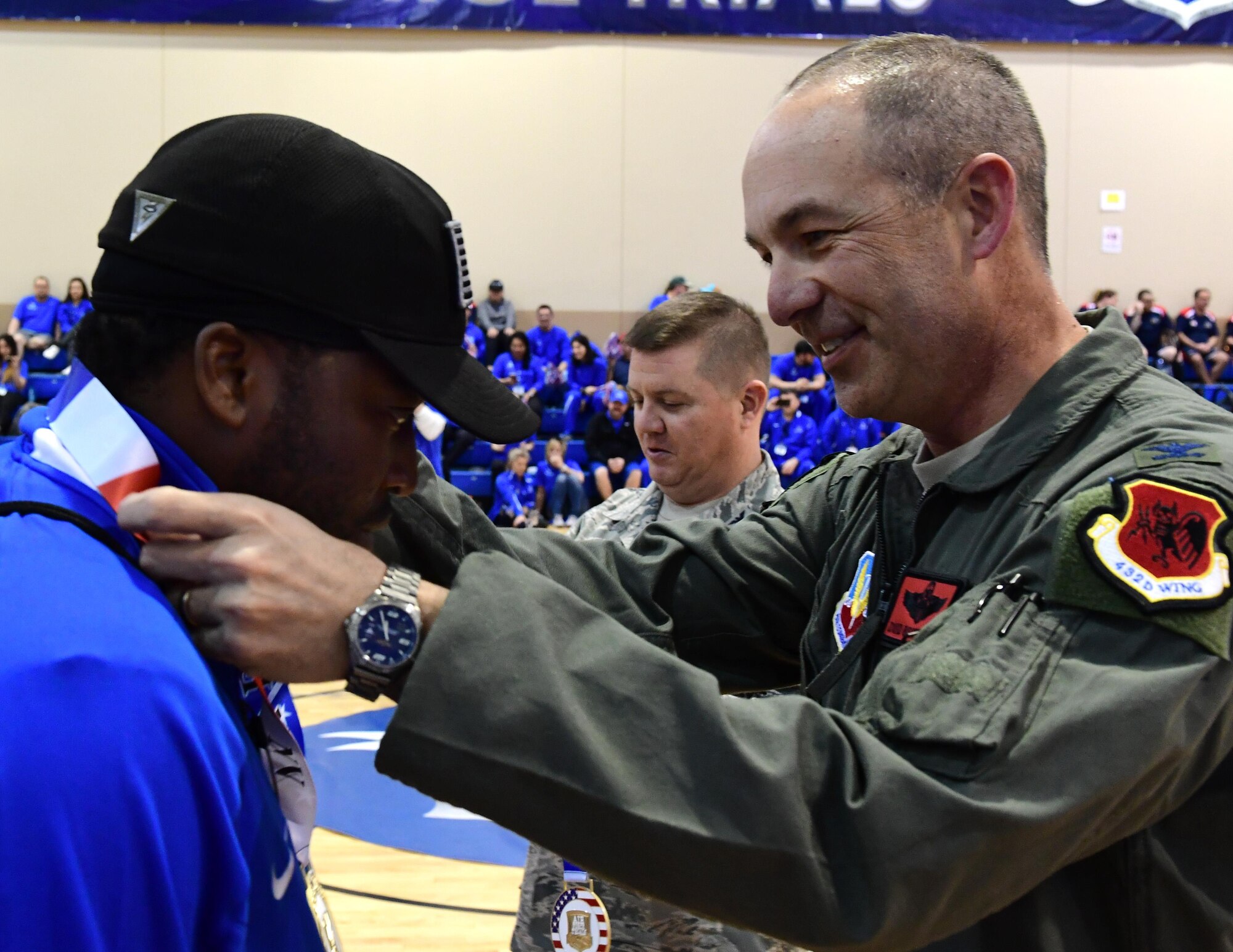 Col. David, 432nd Wing/432 Air Expeditionary Wing vice commander presents a medal to an Air Force Wounded Warrior Trials competitor after competing in the wheelchair basketball competition March 1, 2017, at Nellis Air Force Base, Nev. Competitors participated in the basketball tournament until a third, second and first place team were awarded. The trials allow wounded warriors to compete in sports again. (U.S. Air Force photo by Senior Airman Christian Clausen)