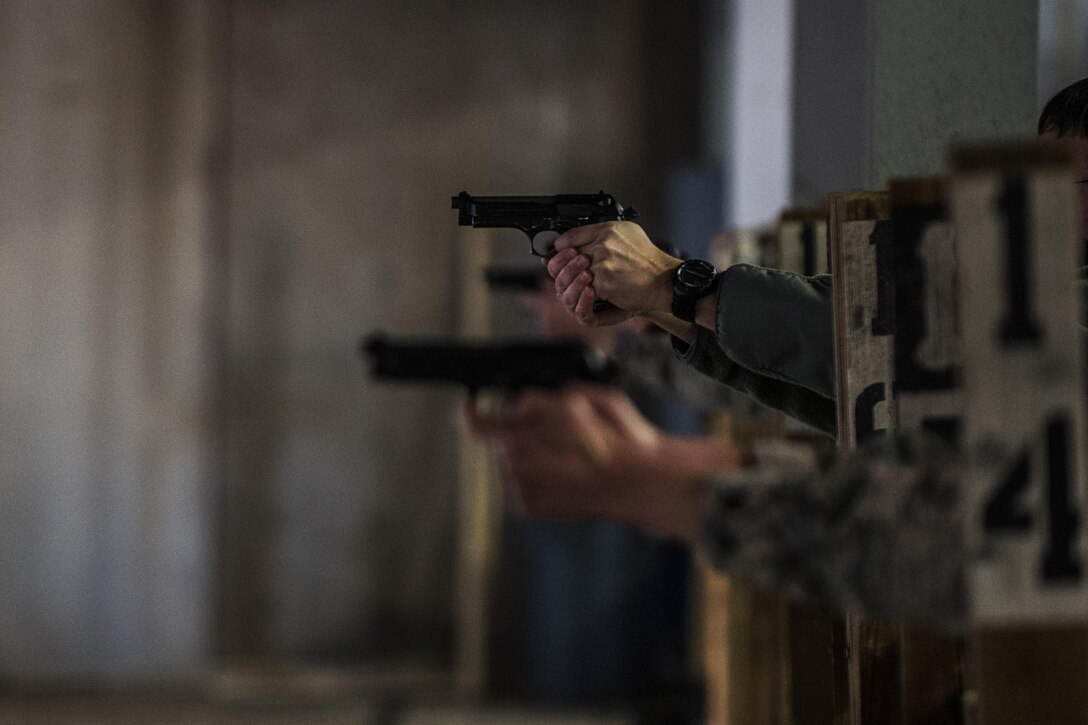 Competitors fire their weapons during the Pistol Excellence in Competition March 2, 2017, at Cannon Air Force Base, N.M. More than 50 competitors participated in the competition which lasted three days. (U.S. Air Force photo by Senior Airman Luke Kitterman/Released)