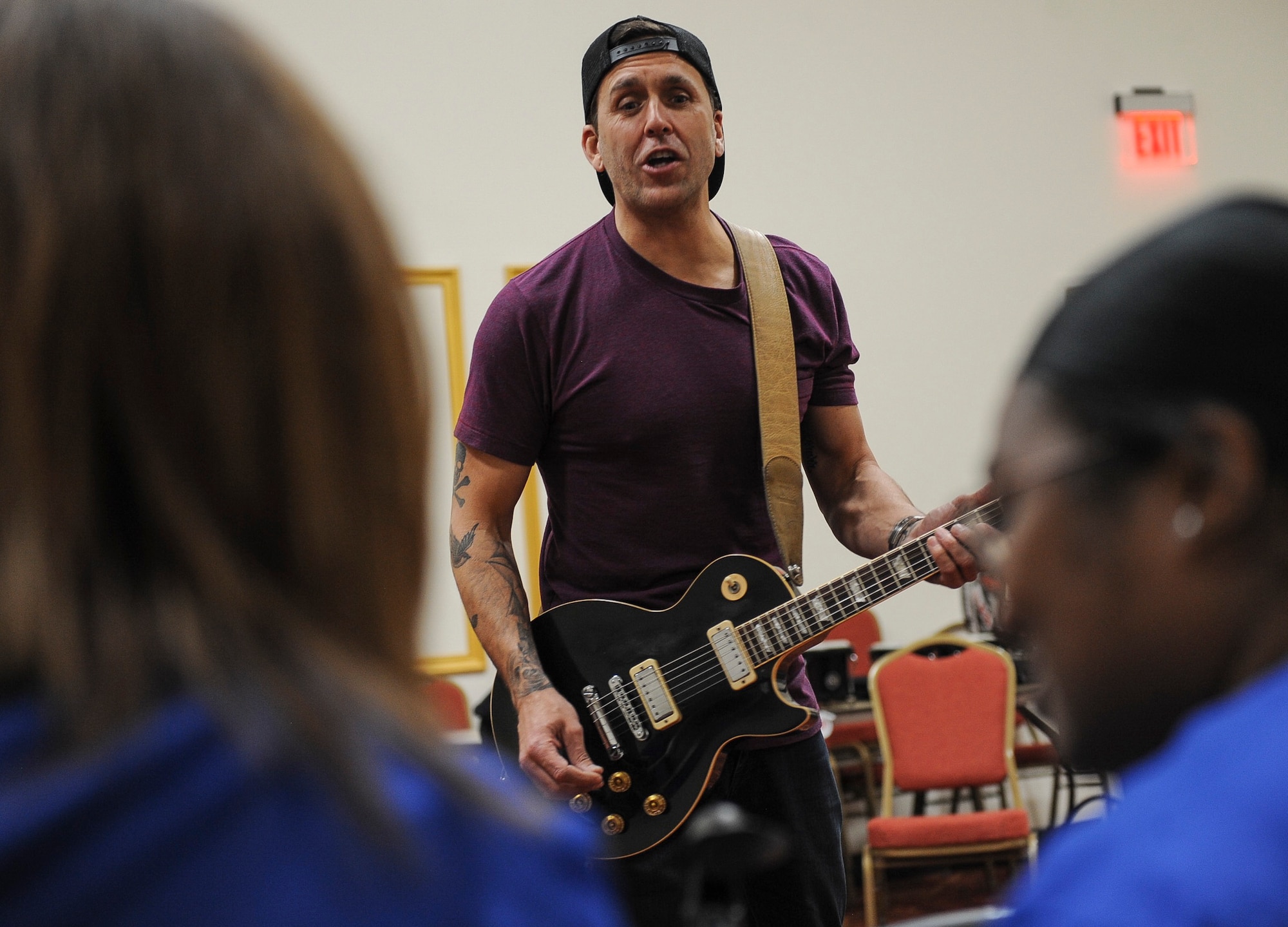 Former Korn guitarist and Rock to Recovery founder Wes Geer shouts pointers to Air Force Wounded Warrior Trials participants while playing the guitar during a Rock to Recovery practice session in Las Vegas, March 1, 2015. Geer played guitar during two interactive music sessions with AFW2 Trial’s band, and helped the group perform their song in front of family and friends during the games’ post-event banquet. (U.S. Air Force photo by Staff Sgt. Siuta B. Ika)