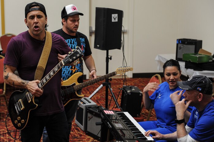 Former Korn guitarist and Rock to Recovery founder Wes Geer gives suggestions to Air Force Wounded Warrior Trials participants during a Rock to Recovery practice session in Las Vegas, March 1, 2015. Geer created the Rock to Recovery program to help people recover through music after seeing its effect on his own recovery from addiction. (U.S. Air Force photo by Staff Sgt. Siuta B. Ika)