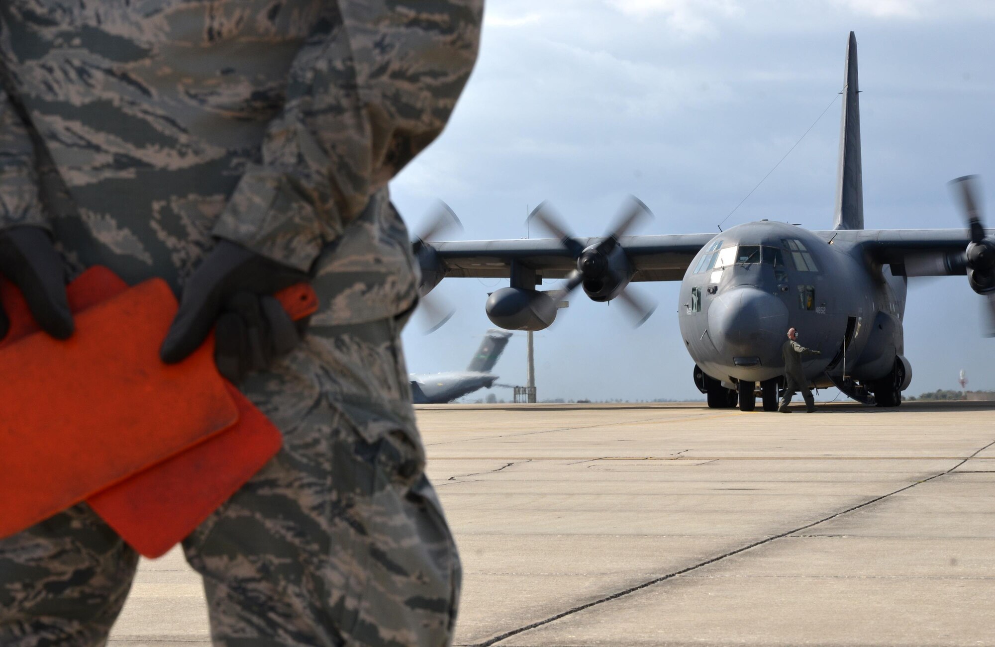 Senior Airman Liam Miner, 720th Aircraft Maintenance Squadron dedicated crew chief, stands by ready to marshall King 52, the first HC-130 configured for Air Force rescue, down the Patrick Air Force Base, Florida, taxiway for the last time March 6, 2017. King 52 will retire at Davis-Monthan Air Force Base, Arizona, with more than 50 years of service. (U.S. Air Force photo/Tech. Sgt. Lindsey Maurice)