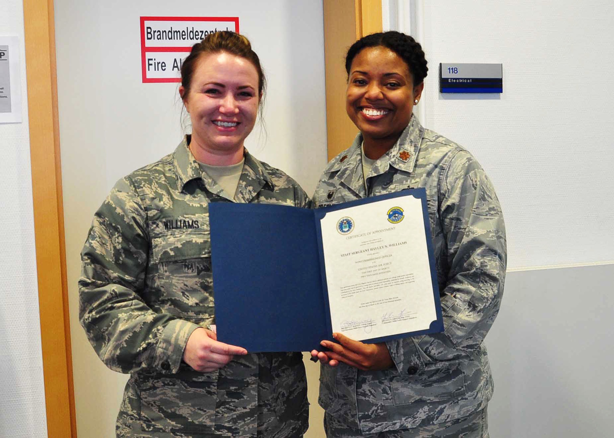Senior Airman Hayley Williams, 944th Force Support Squadron journeyman, receives her promotion certificate from Maj. Melissa Greene, 944 FSS commander, Feb 28 during her annual tour at Ramstein Air Base, Germany. ( U.S. Air Force photo by Maj. Elizabeth Magnusson)