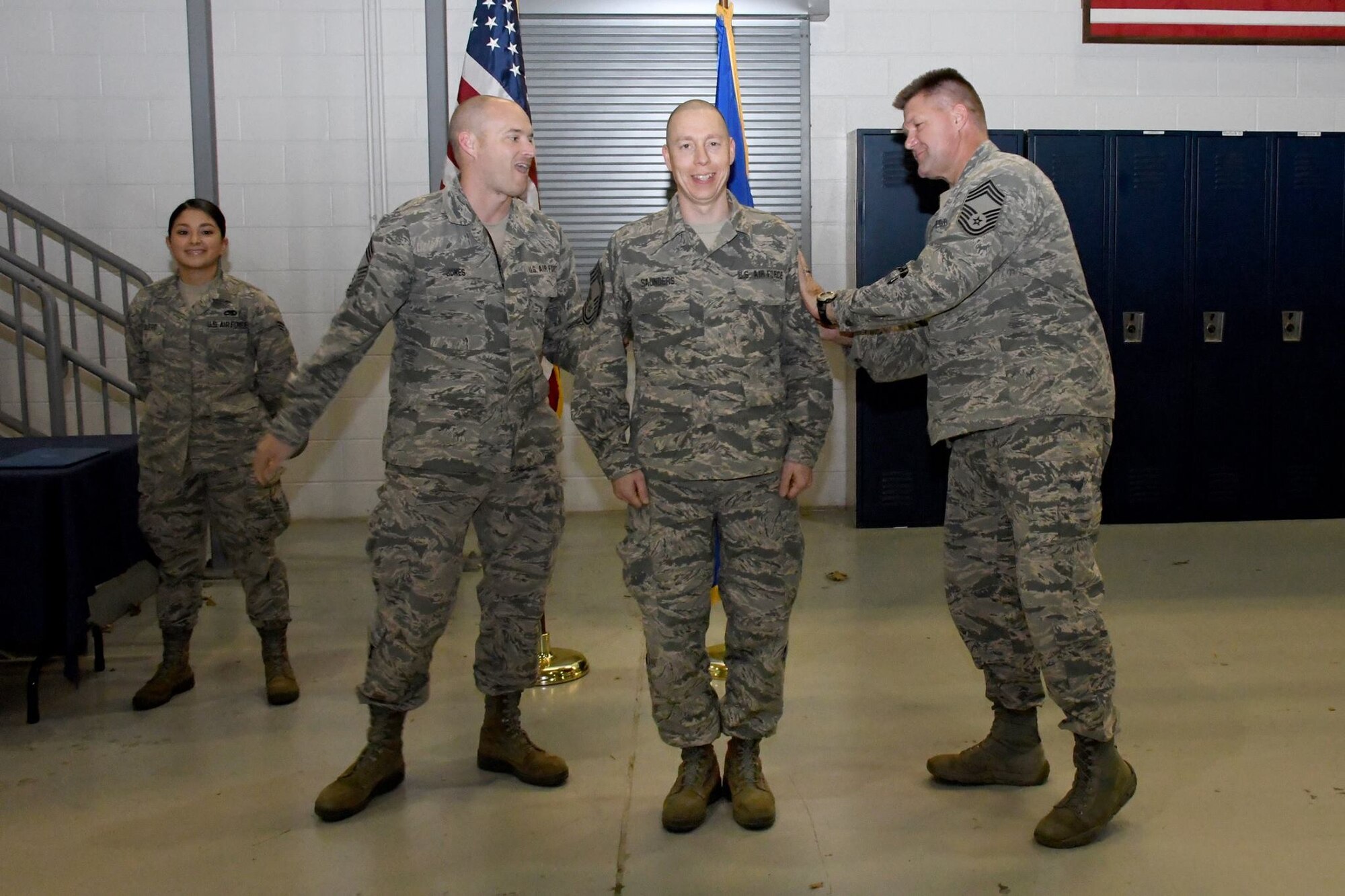 Chief Master Sgt. Glen F. Saunders Jr., quality assurance superintendent with the 94th Maintenance Group, is "patched" by Chief Master Sgt. Christopher Sokolick, maintenance superintendent with the 94th MG, and Chief Master Sgt. Marvin Jones, maintenance operations superintendent with the 94th MG, during his promotion ceremony March, 5, 2017 at Dobbins Air Reserve Base, Georgia. (U.S. Air Force photo/Airman 1st Class Justin Clayvon)