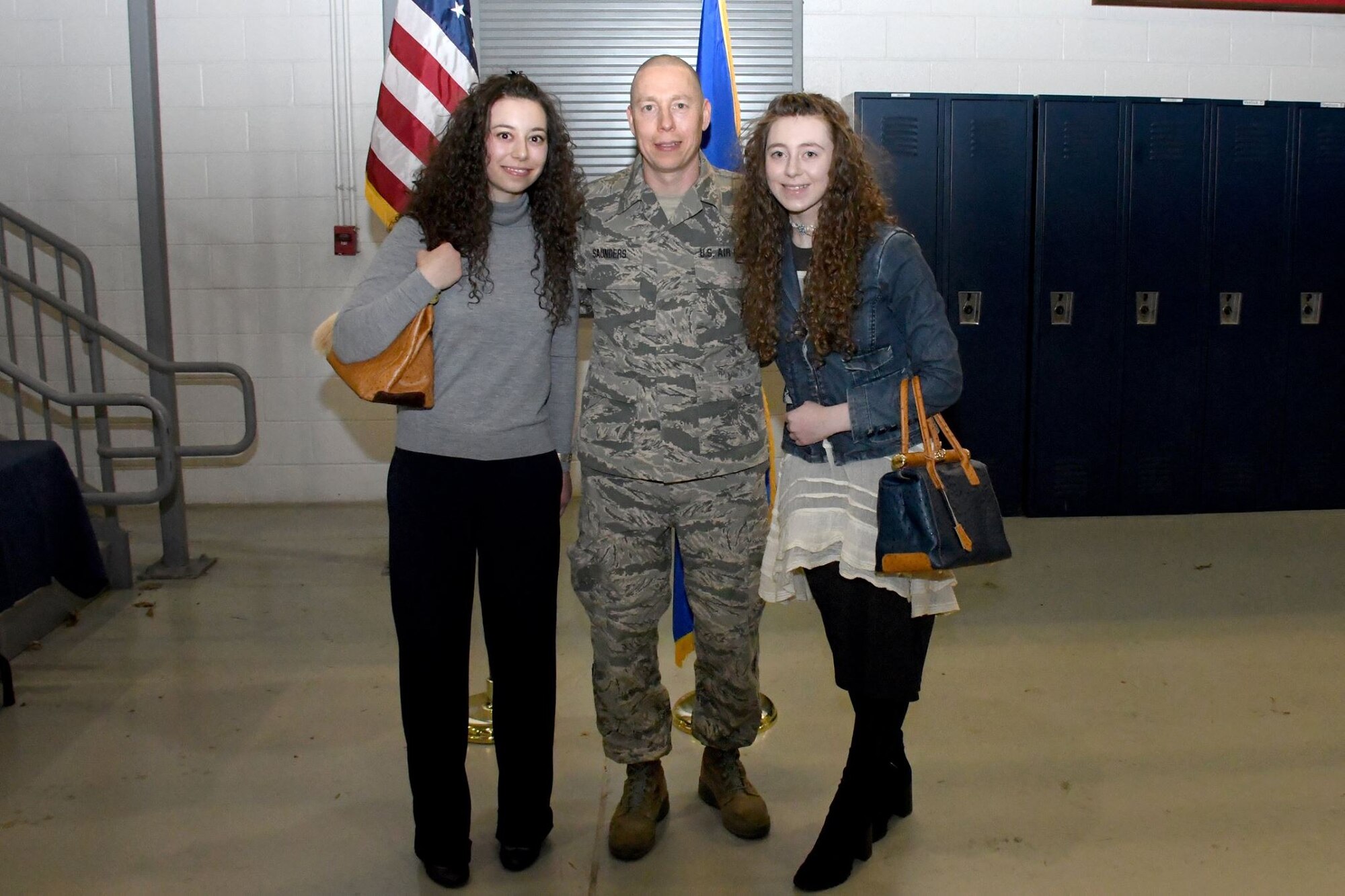 Chief Master Sgt. Glen F. Saunders Jr., quality assurance superintendent with the 94th Maintenance Group, poses with his daughters Drake and Sage Saunders, after his promotion ceremony March, 5, 2017 at Dobbins Air Reserve Base, Georgia. (U.S. Air Force photo/Airman 1st Class Justin Clayvon)