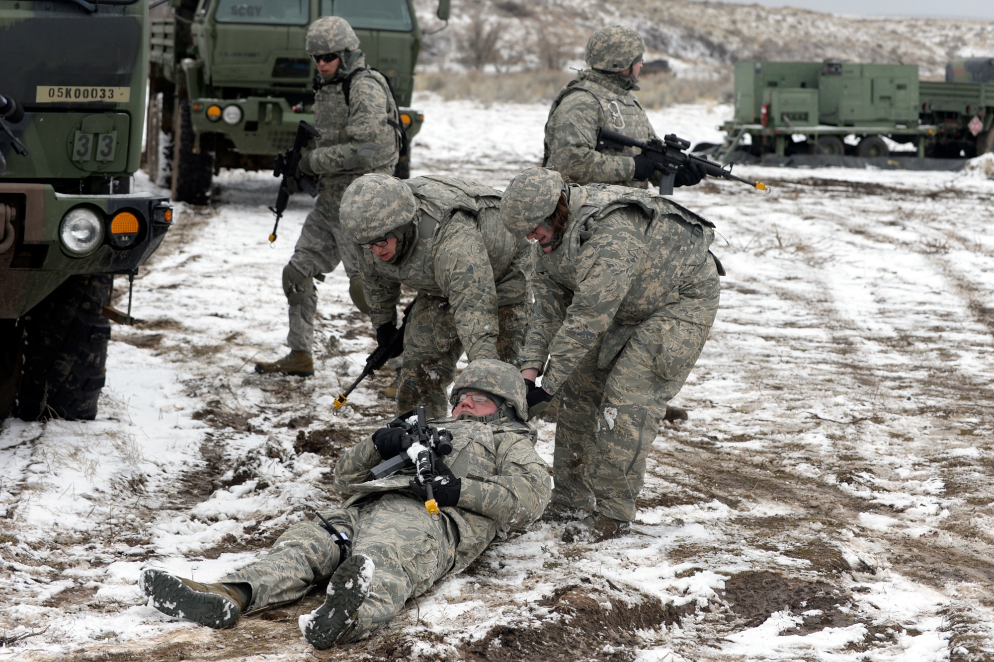 Airman 1st Class Paul Leszczewski and Senior Airman Kristina Stubbe, 729th Air Control Squadron, drag a simulated wounded Airman, Senior Airman Thomas Smith, while practicing site defense during a expeditionary training exercise Feb. 23. (U.S. Air Force photo by Todd Cromar)