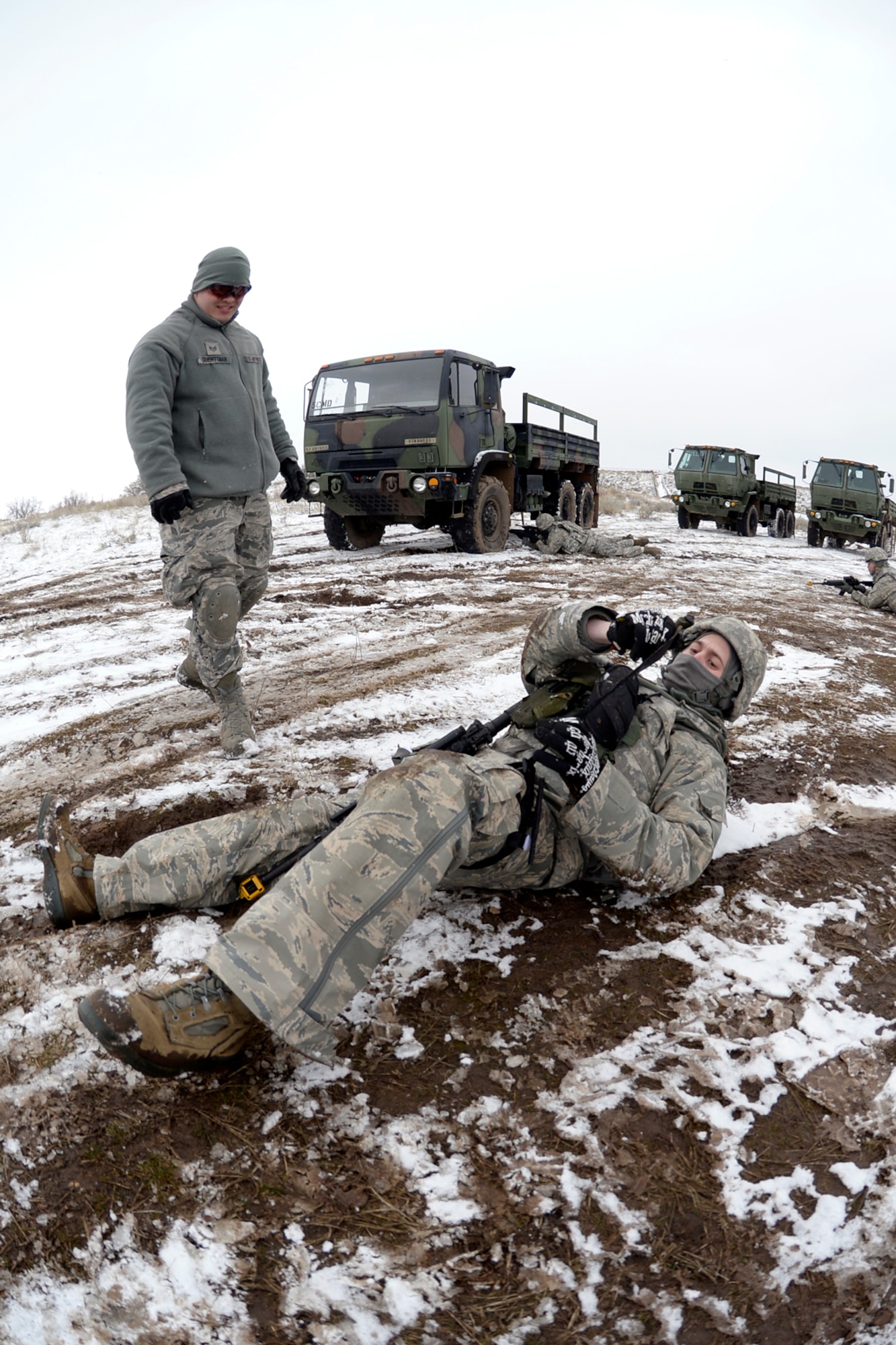 Staff Sgt. Jason Smith, 729th Air Control Squadron, applies a tourniquet to his leg and is briefed on care-under-fire procedures by Staff Sgt. Jeffrey Guerttman, 729th Air Control Squadron, during training Feb. 23. (U.S. Air Force photo by Todd Cromar)