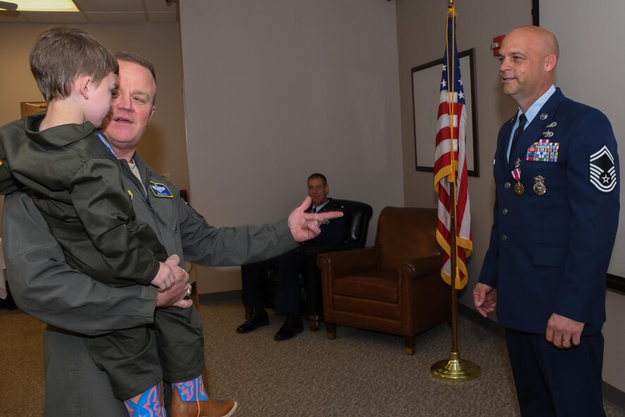 U.S. Air Force Col. Bruce Cox, 307th Bomb Wing commander, speaks to Maverick Weeks, the grandson of Senior Master Sgt. Wendell Weeks, 307th Security Forces Squadron training manager, at Barksdale Air Force Base, La., March 4, 2017.   Cox and a large crowd of well-wishers turned out for Weeks’ retirement ceremony.   Weeks retired with 26 years of service in the Air Force. (U.S. Air Force photo by Tech. Sgt. Ted Daigle/Released)
