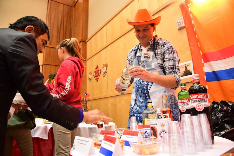 Martijn De Boer fills cups at the Dutch table during the International Buffet at Hill Air Force Base, Utah, March 1, 2017. Nineteen Foreign Liaison Officers and their families offered food and drink from 12 countries during the event. (U.S. Air Force photo/R. Nial Bradshaw)
