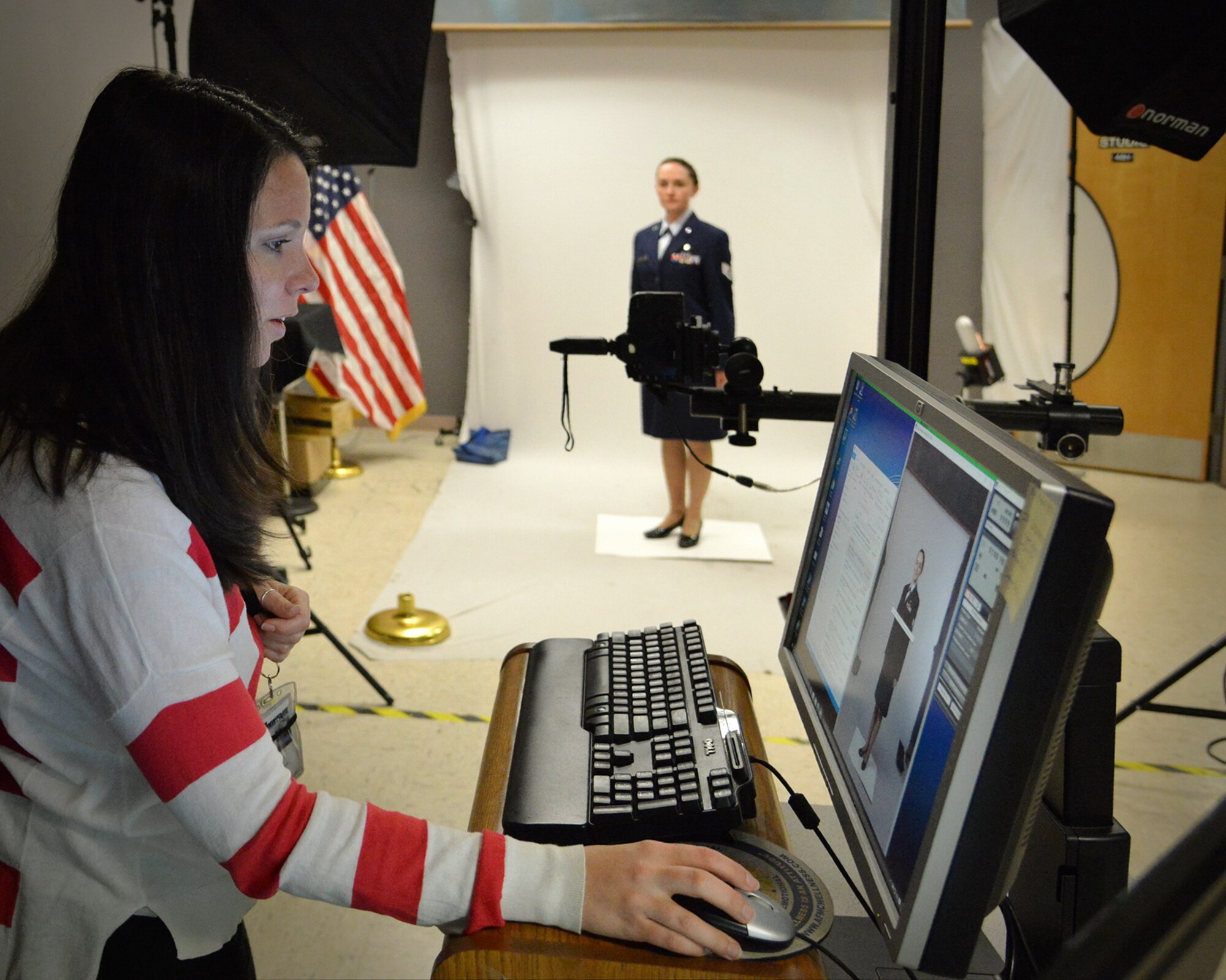 Staff Sgt. Tichina Myers, 377th Aerospace Medicine Squadron, works with base photographer Jamie Burnett on an official photo. Service members who are in need of an official photo should be prepared before contacting multimedia. 
