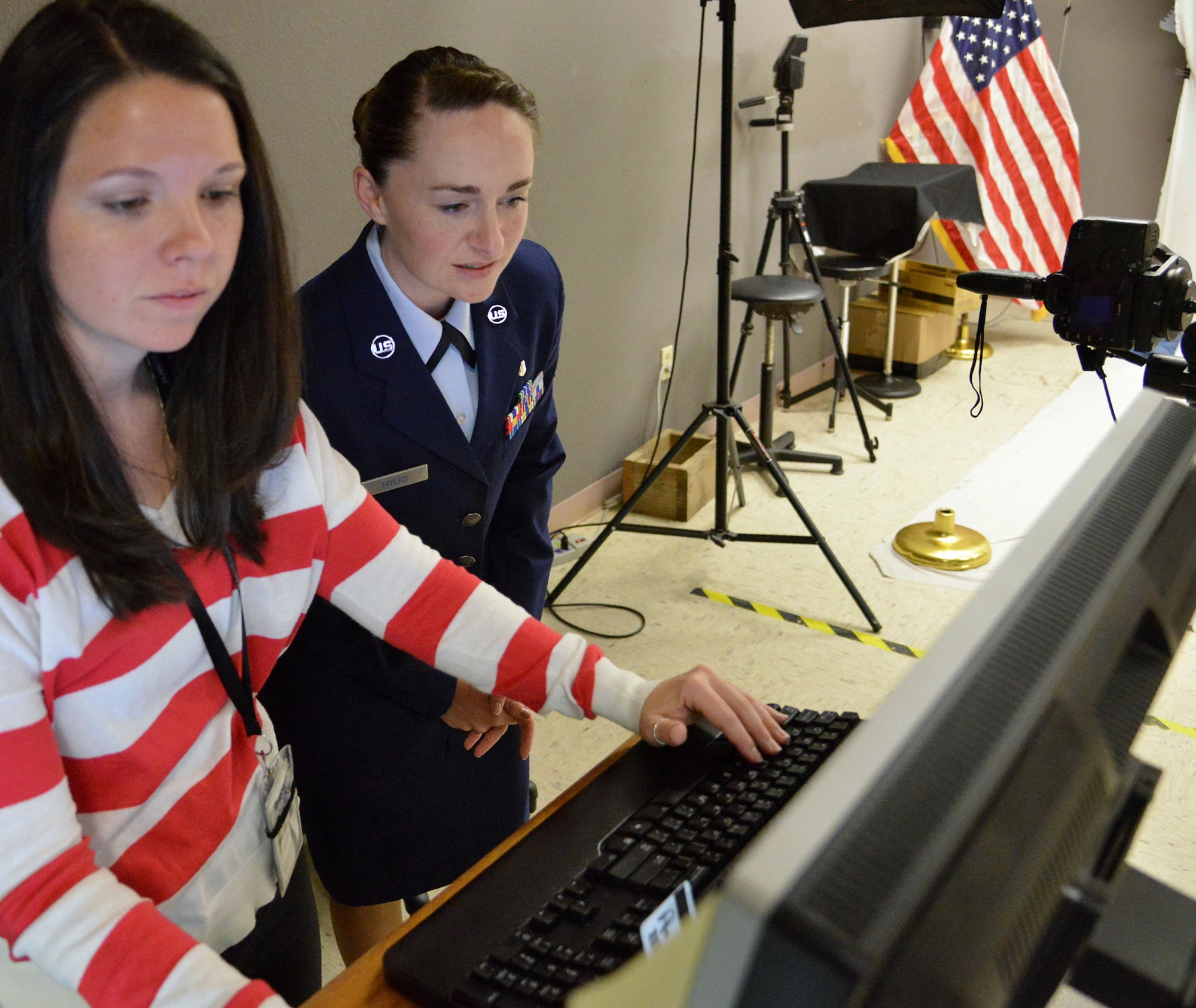 Staff Sgt. Tichina Myers, 377th Aerospace Medicine Squadron, works with base photographer Jamie Burnett on an official photo. Service members who are in need of an official photo should be prepared before contacting multimedia. 