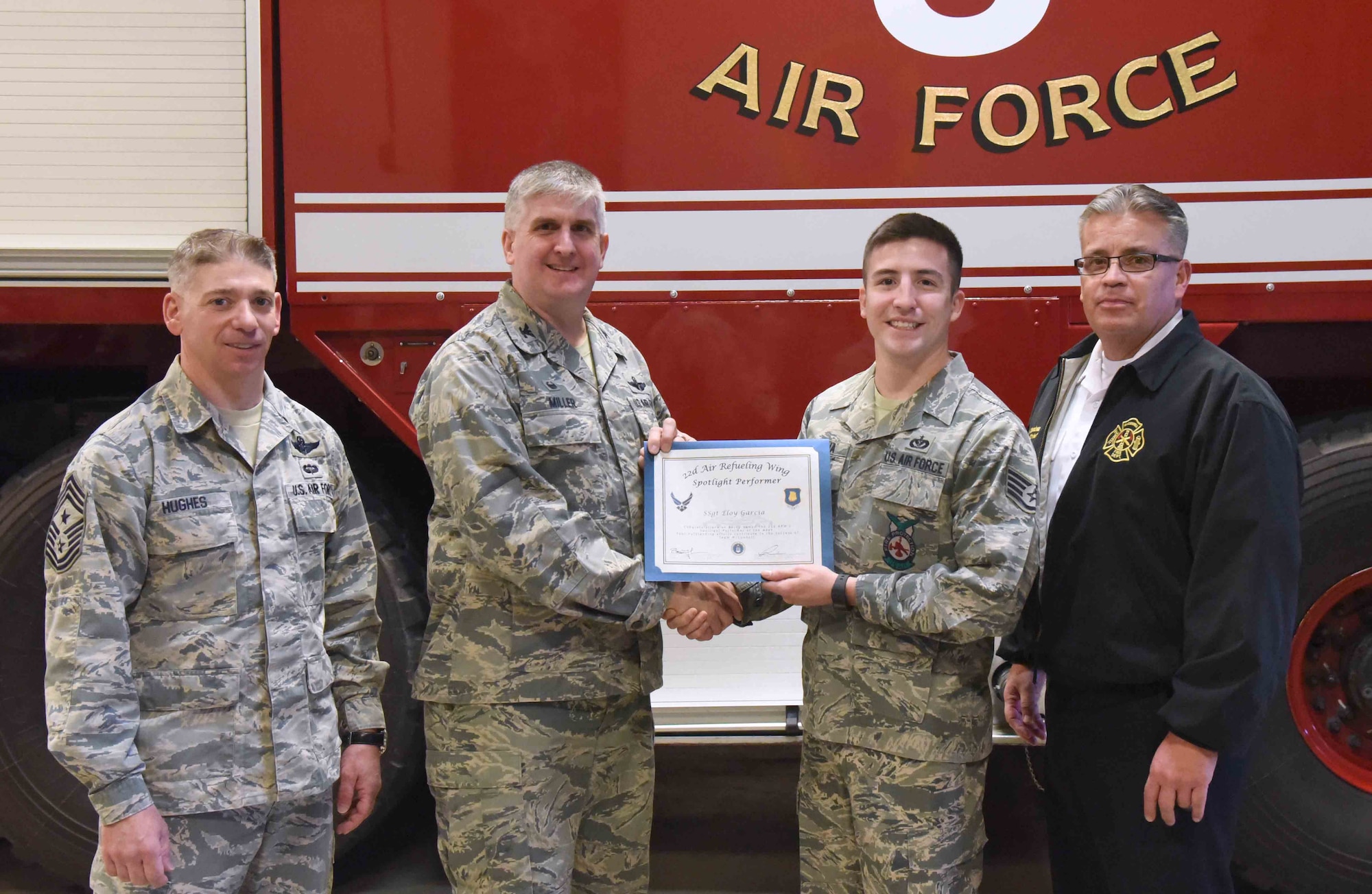 Staff Sgt. Eloy Garcia, 22nd Civil Engineer Squadron fire inspector, poses with 22nd Air Refueling Wing leadership, Feb. 1, 2017, at McConnell Air Force Base, Kan. Garcia received the spotlight performer for the week of Jan 2-6. (U.S. Air Force photo/Airman 1st Class Erin McClellan) 