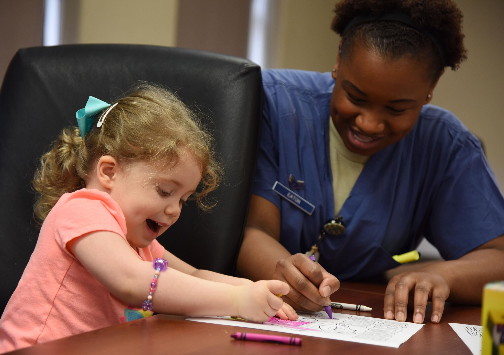 Senior Airman Chantel Eaton, 81st Dental Squadron dental technician, colors with Sarah Goebel, daughter of Tech. Sgt. Eric Goebel, 81st Security Forces Squadron flight chief, during the 7th Annual Give Kids a Smile Day at the dental clinic March 1, 2017, on Keesler Air Force Base, Miss. The event was held in recognition of National Children’s Dental Health Month and included free dental exams, radiographs and cleanings for more than 95 children age 2 and older. (U.S. Air Force photo by Kemberly Groue)