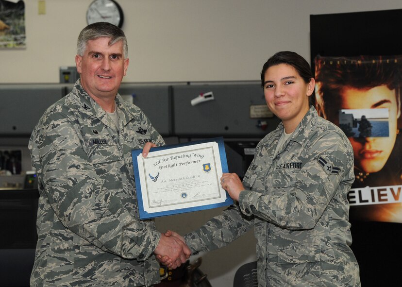 Airman 1st Class Meredith Lindsay, 22nd Medical Support Squadron medical logistics technician, poses with Col. Albert Miller, 22nd Air Refueling Wing commander, Feb. 23, 2017, at McConnell Air Force Base, Kan. Lindsay received the spotlight performer for the week of Feb. 6-10. (U.S. Air Force photo/Airman 1st Class Jenna K. Caldwell) 