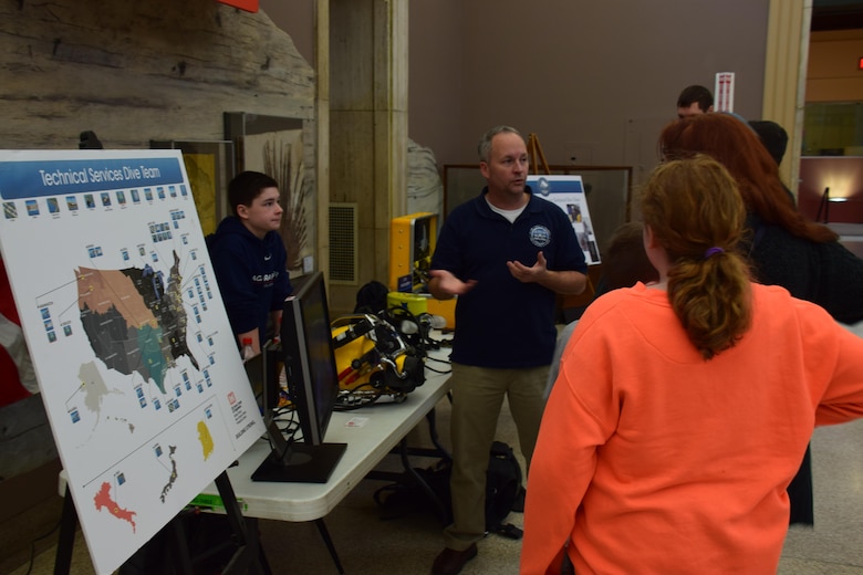 Diver Shanon Chader talks about the Buffalo District Dive Team with some visitors at the Buffalo Museum of Science.