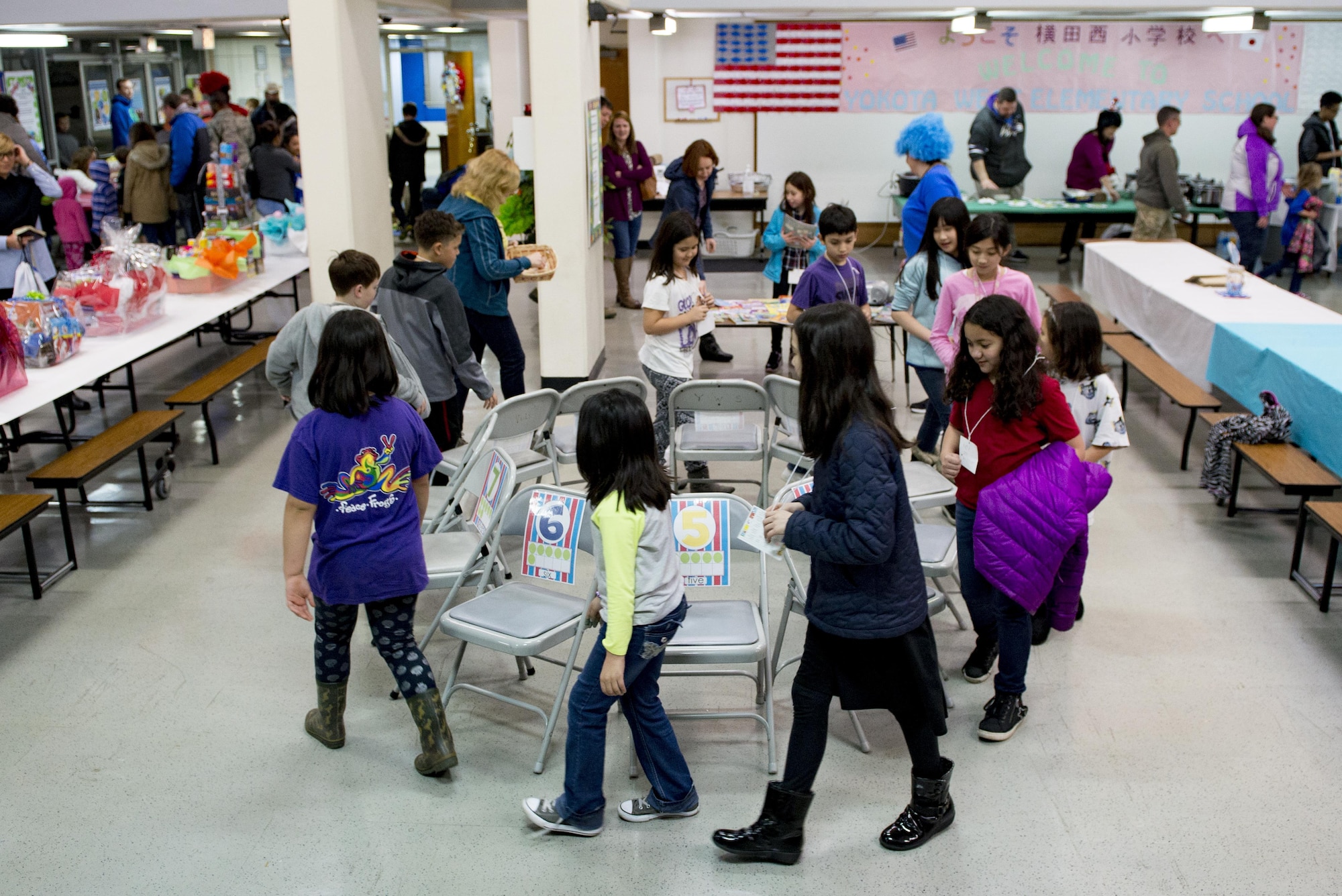 Children play the game Musical Chairs to win books at West Elementary School during a National Read Across America Day event, Mar. 2, 2017 at Yokota Air Base, Japan. The Dr. Seuss Family Night event at West Elementary School included various activities designed to encourage and show the enjoyment in reading to children. (U.S. Air Force photo by Airman 1st Class Donald Hudson)