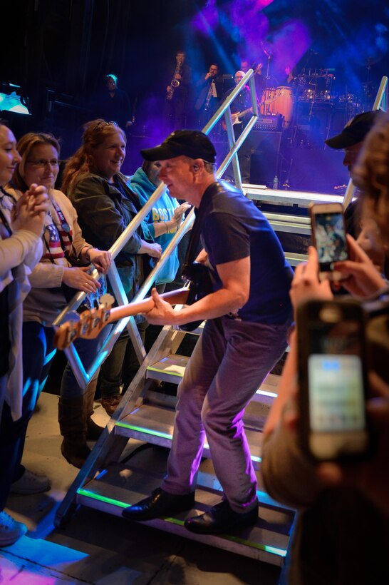 Gary Sinise, the Lt. Dan Band, electric bass player, leaves the stage to play among the crowd at Barksdale Air Force Base, La. March 3, 2017. In 2011, Sinise founded the Gary Sinise Foundation to help service members, veterans, first responders and their families. (U.S. Air Force photo/Airman 1st Class Stuart Bright)