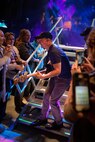 Gary Sinise, the Lt. Dan Band, electric bass player, leaves the stage to play among the crowd at Barksdale Air Force Base, La. March 3, 2017. In 2011, Sinise founded the Gary Sinise Foundation to help service members, veterans, first responders and their families. (U.S. Air Force photo/Airman 1st Class Stuart Bright)