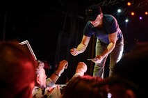 Gary Sinise, the Lt. Dan Band electric bass player, signs an autograph for a member of Team Barksdale at Barksdale Air Force Base, La. March 3, 2017. Sinise played the character Lt. Dan in the movie “Forrest Gump”. (U.S. Air Force photo/Airman 1st Class Stuart Bright)